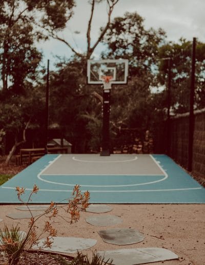 Photo of blue basketball court with paving