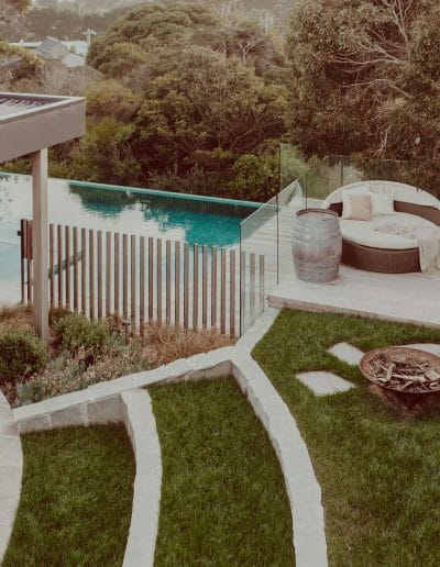 Photo of stone and grass landscaping next to pool area