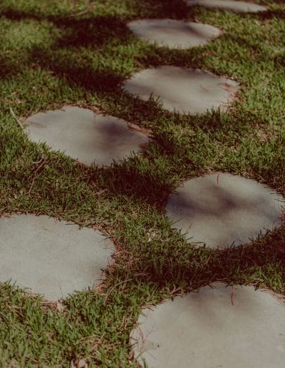 Closeup of rounded stone pavers set in lawn