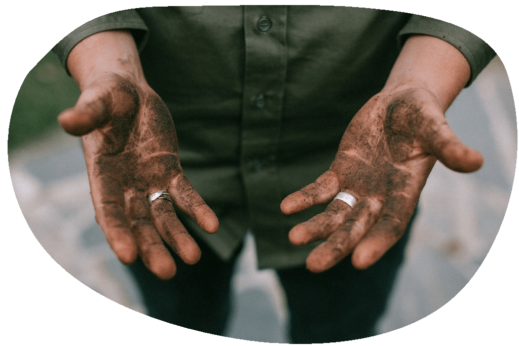 Photo of two hands with dirt from landscaping