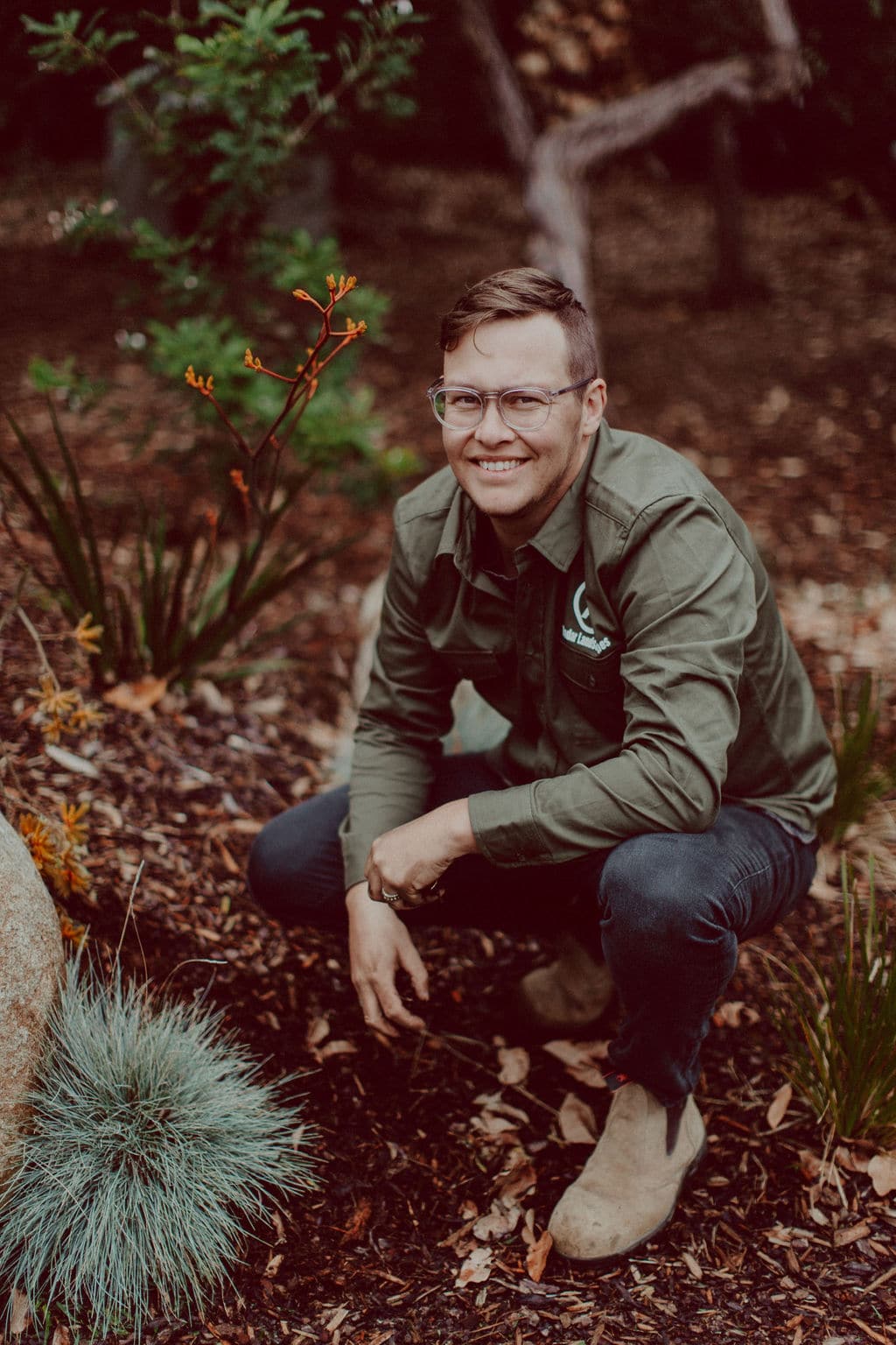 Photo of Radar Landscapes Tim Looker smiling and kneeling in a garden